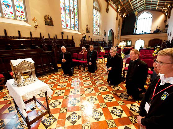 priests praying to heart